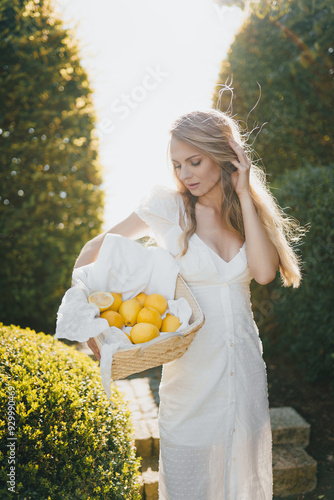 photo in Italian style with a sexy young woman in a light summer dress a peasant woman picking fruits