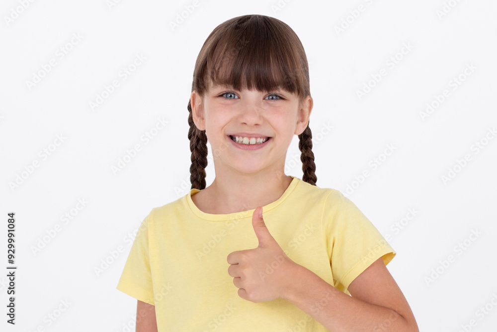 Saying yes. Smiling positive girl, showing thumb up to like and approve, praise good thing, recommending product, white background Saying yes. Smiling positive girl, showing thumb up to like and approve, praise good thing, recommending product, white background