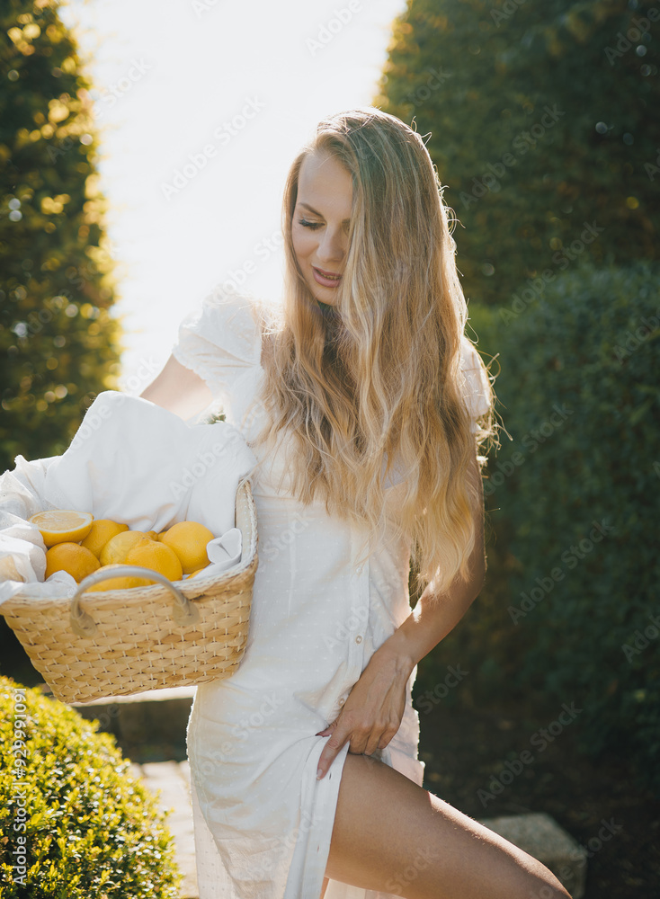 photo in Italian style with a sexy young woman in a light summer dress a peasant woman picking fruits