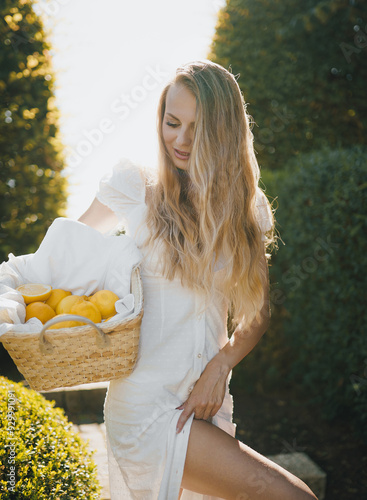 Obraz na płótnie photo in Italian style with a sexy young woman in a light summer dress a peasant woman picking fruits w salonie