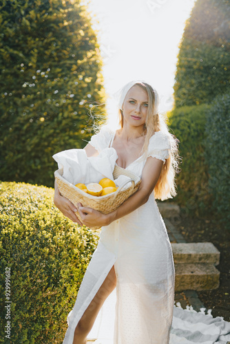 Obraz na płótnie photo in Italian style with a sexy young woman in a light summer dress a peasant woman picking fruits w salonie
