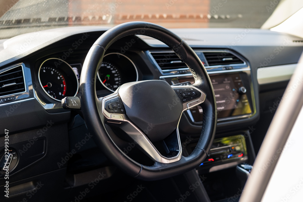 Car steering wheel, interior view of modern car and black dashboard with sun light. Car steering wheel, interior view of modern car and black dashboard with sun light.
