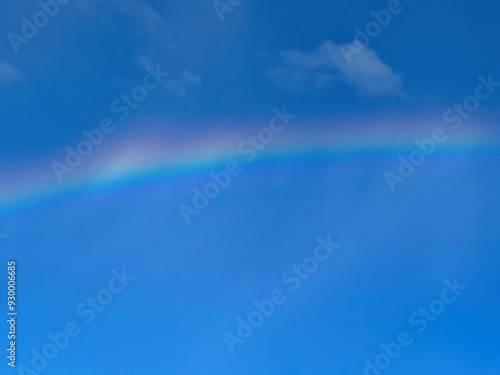 Rainbow with sunny blue sky