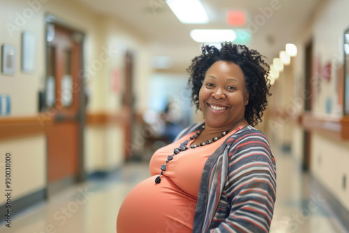 Africana American middle age senior gray haired regnant woman expecting baby at aged pregnancy smiling holding belly in hospital. Motherhood in any age, old-timer