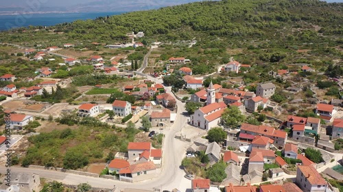 Drone aerial view of Gornje Selo, Solta, showcasing traditional stone houses, winding streets, and surrounding lush landscapes on the island photo