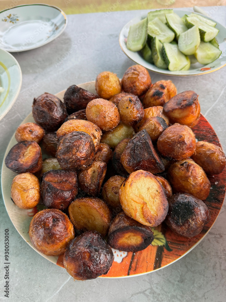 Fototapeta premium Whole potatoes, deep-fried. With a golden crust.