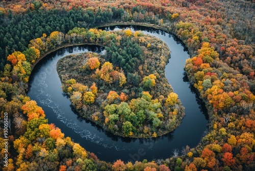 Breathtaking aerial view of a winding river surrounded by colorful autumn foliage