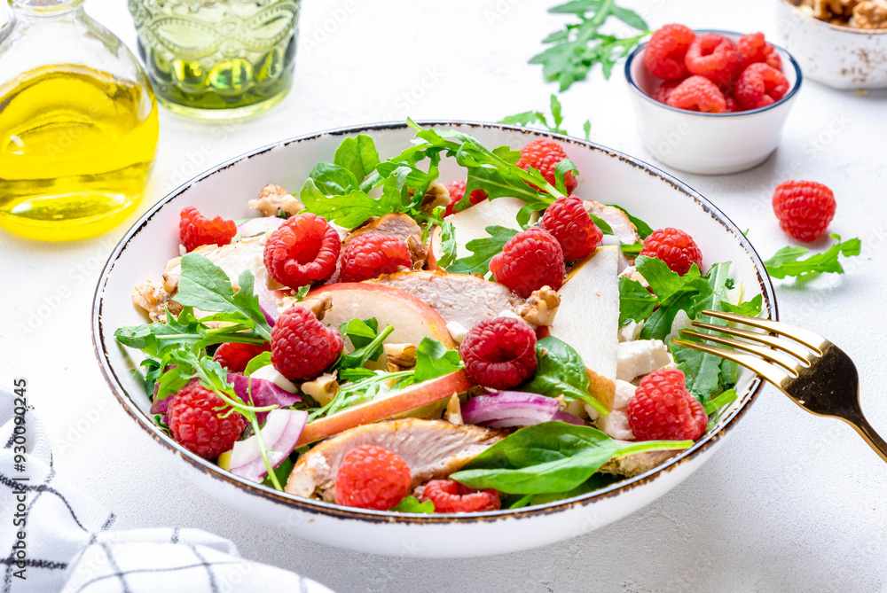 Delicious summer salad with raspberries, chicken meat, fresh pears, ricotta cheese, red onion, nuts, spinach and arugula, white background, top view Delicious summer salad with raspberries, chicken meat, fresh pears, ricotta cheese, red onion, nuts, spinach and arugula, white background, top view