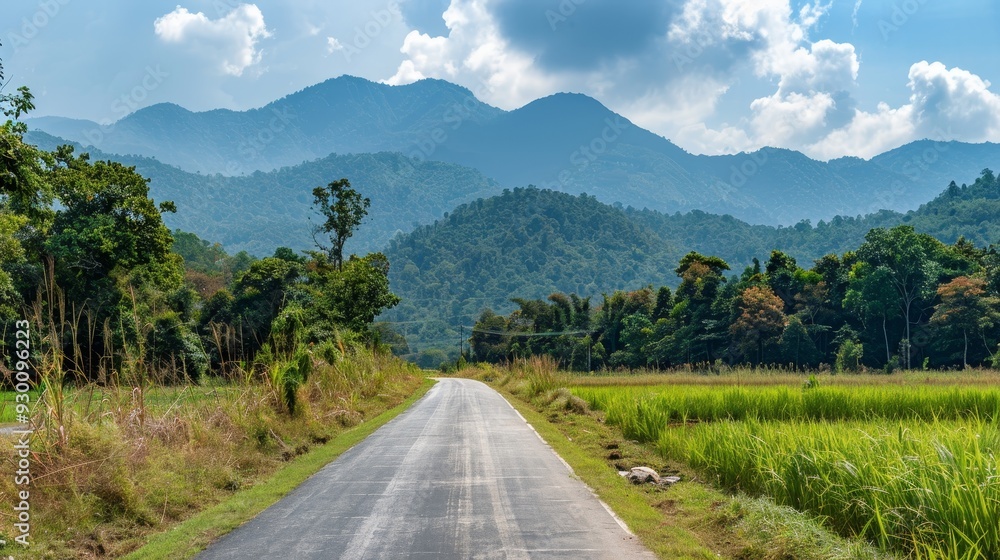 Scenic View of Asphalt Road Square Surrounded by Green Mountains and Clouds under a Clear Sky, Depicting Natural Serenity and Open Landscape Scenic View of Asphalt Road Square Surrounded by Green Mountains and Clouds under a Clear Sky, Depicting Natural Serenity and Open Landscape