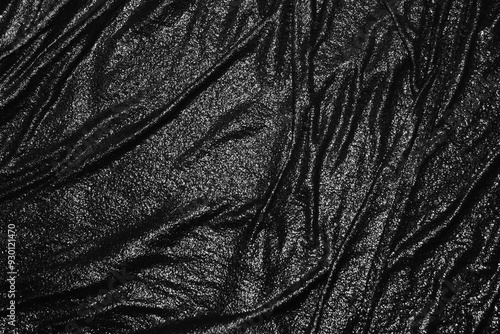 Abstract black background. Dark textured background. Black background with wavy texture. Wet black cloth texture