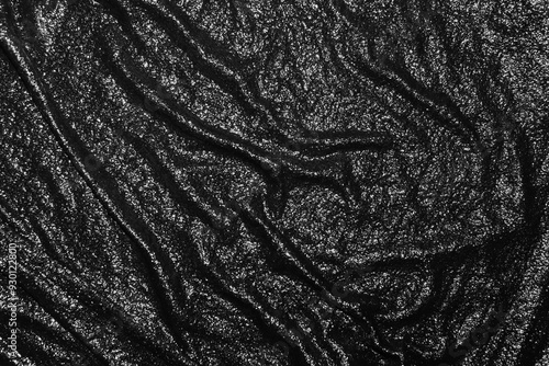 Dark textured background. Black background with wavy texture. Wet black cloth texture. Abstract black background