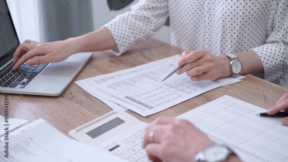 Professional female bookkeeper or auditor are working on business finances with a colleague, using calculator and laptop. Finance audit and taxes Professional female bookkeeper or auditor are working on business finances with a colleague, using calculator and laptop. Finance audit and taxes