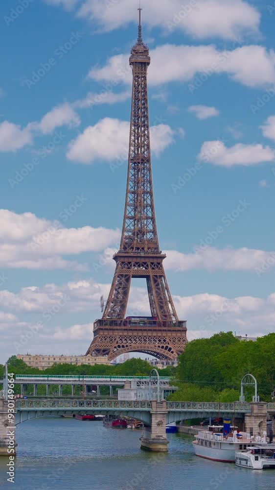 Establishing shot of Paris, France. Landmark iron tower in background. View of the Eiffel Tower from one of the streets of Paris. Parisian architecture of houses in the center of the capital Establishing shot of Paris, France. Landmark iron tower in background. View of the Eiffel Tower from one of the streets of Paris. Parisian architecture of houses in the center of the capital