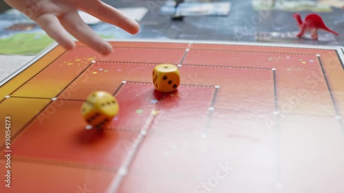 The hand throws yellow dices on the playing field. Gaming moments in dynamics. Luck and excitement. Board games strategy. Slow motion.