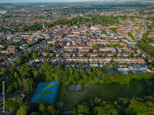 Obraz na płótnie Swindon old town with church at sunset in summer. High altitude aerial view from Town Gardens. Recreational grounds with tennis court. Panoramic view of the town. w salonie