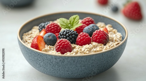 A vibrant bowl of oatmeal topped with fresh berries, including raspberries, blueberries, and blackberries, perfect for a healthy breakfast.