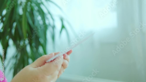 Female hand grips sealed white envelope, unopened letter, blackmail, dreading contents. suspense receiving unwelcome mail, nervous moment, fearful correspondence