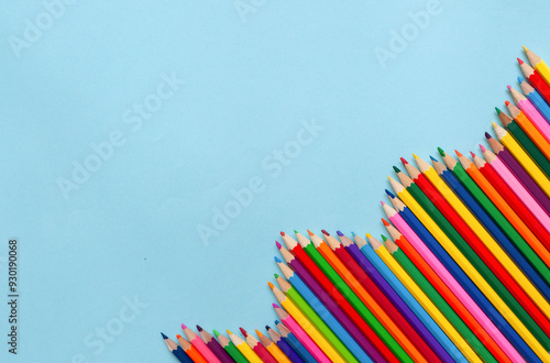 back-to-school concept, colored pencils stacked in a row in the corner, empty space. High quality photo