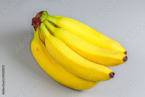 Cluster of ripe bananas on a gray background close-up photo