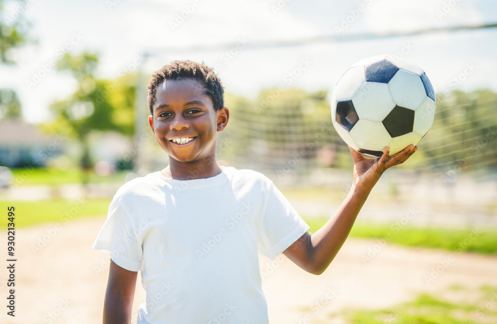 Young kid playing soccer on a playfield Young kid playing soccer on a playfield