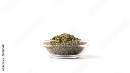 A front-facing shot of dried oregano in a transparent bowl, isolated on white, with a minimalistic composition that highlights the herb's texture.