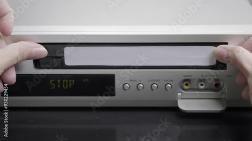 VHS videocassette is put into the VCR to watch the