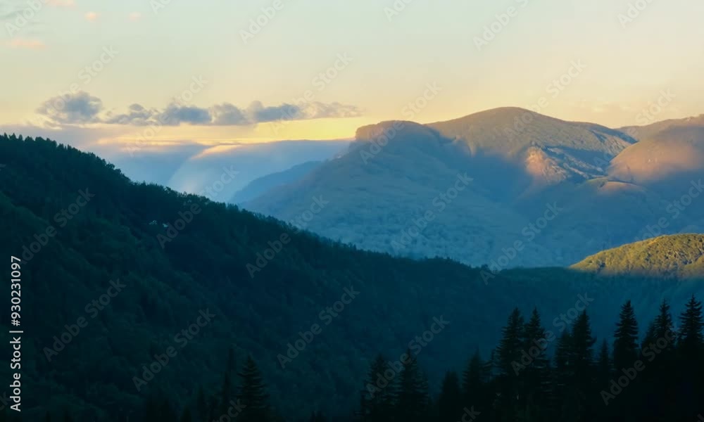 A view of a mountain range with a bright blue sky and some wispy clouds. A view of a mountain range with a bright blue sky and some wispy clouds.