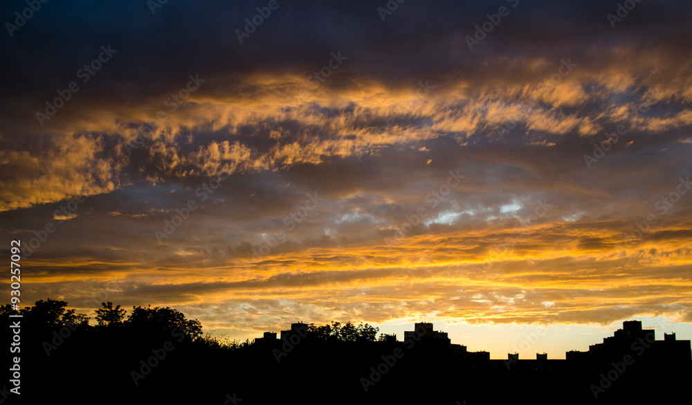 Sky in a fire sunset, beautiful sunrise or sunset sky over the sity background Sky in a fire sunset, beautiful sunrise or sunset sky over the sity background