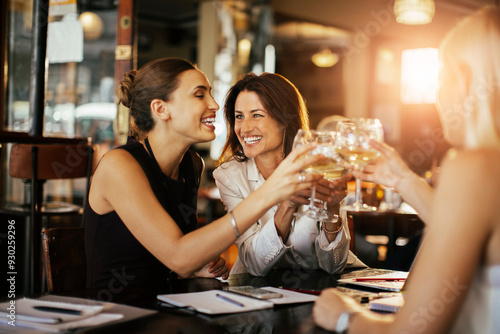 Businesswomen toasting with wine glasses in a restaurant