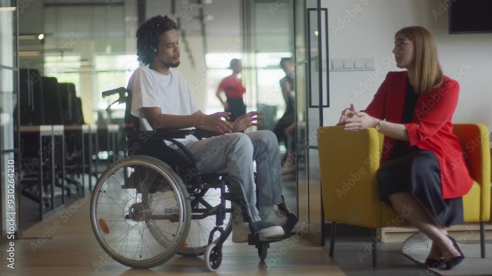 African American businessman in a wheelchair engages in a professional discussion with his colleague, addressing various business challenges and exploring solutions in an inclusive and diverse modern African American businessman in a wheelchair engages in a professional discussion with his colleague, addressing various business challenges and exploring solutions in an inclusive and diverse modern