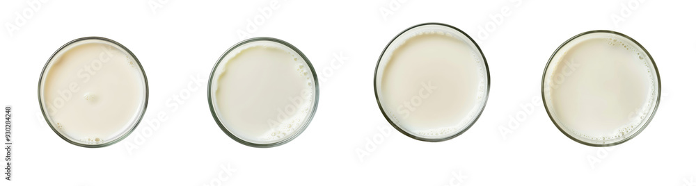 Top view of four glasses filled with fresh milk, emphasizing nutrition and healthy eating for World Milk Day Top view of four glasses filled with fresh milk, emphasizing nutrition and healthy eating for World Milk Day