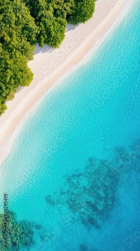 Aerial of a pristine ocean coastline with crystal-clear turquoise waters lapping against white sandy beaches and a coral reef visible beneath the surface