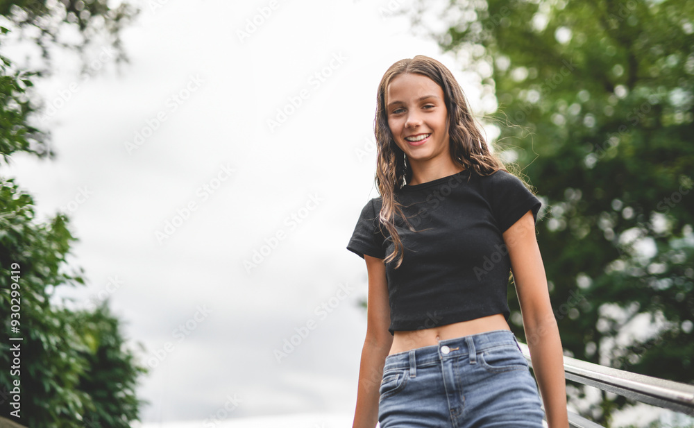 young girl standing at city street. Outside portrait of joyful beautiful teen over urban background. young girl standing at city street. Outside portrait of joyful beautiful teen over urban background.