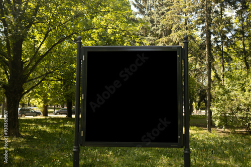 Obraz na płótnie Mockup of the blank black street city outdoor advertising square billboard in black frame at park entrance. High quality photo w salonie