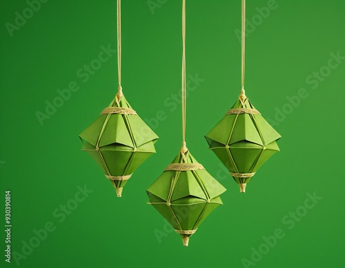 3D Realistic Hanging Green Ketupat in Solid Green Background. Ketupat is Element for Ramadan and Eid Celebration in Indonesia and Malaysia photo