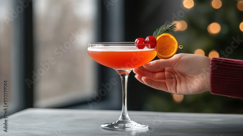 A vibrant cocktail garnished with cherries and orange slice, served in a stylish glass, perfect for festive gatherings. photo