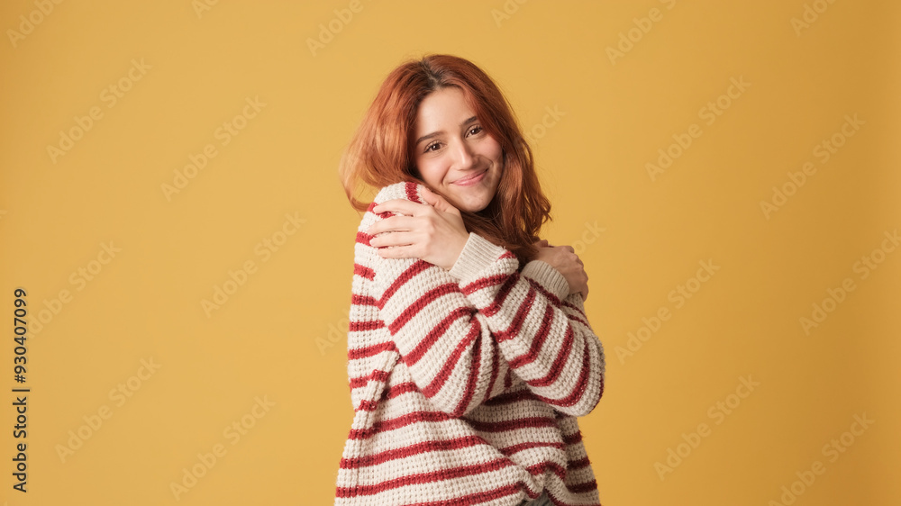 © Andrii Nekrasov - Cute red-haired woman dressed in sweater hugs herself looking at camera on yellow background. Beautiful girl poses in studio with blank space on yellow wall for your promotion © Andrii Nekrasov - Cute red-haired woman dressed in sweater hugs herself looking at camera on yellow background. Beautiful girl poses in studio with blank space on yellow wall for your promotion