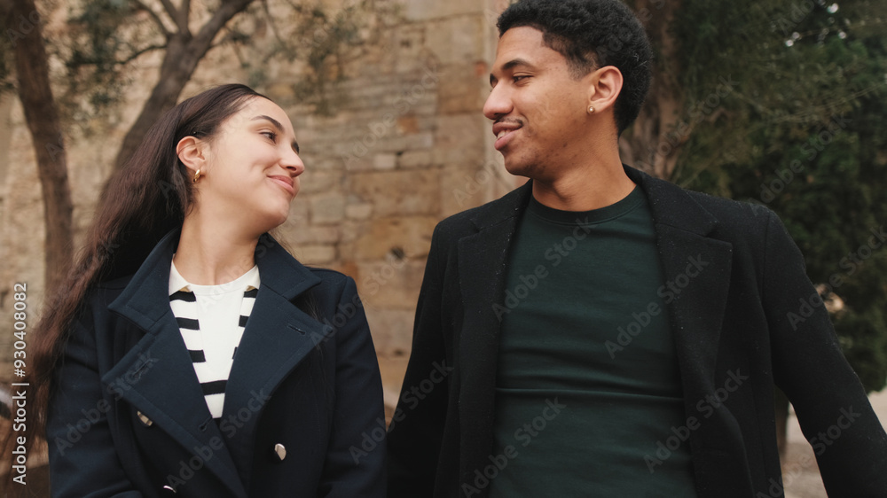 Stylish young couple posing in front of historic cathedral facade, showcasing urban fashion and togetherness Stylish young couple posing in front of historic cathedral facade, showcasing urban fashion and togetherness