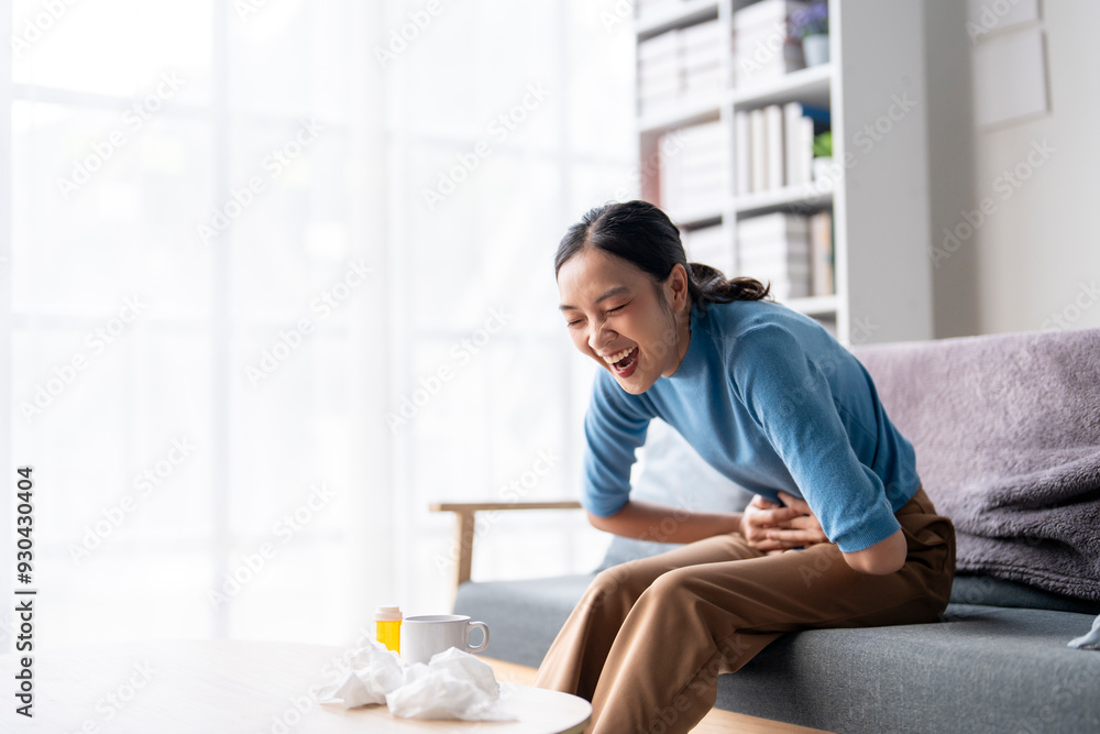A woman is laughing while sitting on a couch A woman is laughing while sitting on a couch