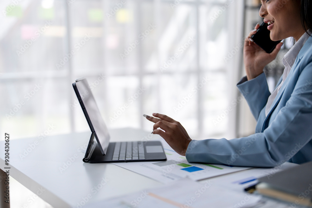 A woman is sitting at a desk with a laptop and a cup of coffee A woman is sitting at a desk with a laptop and a cup of coffee