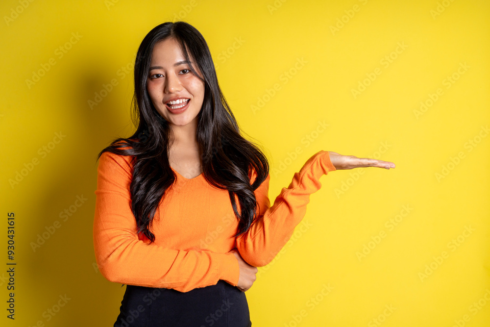 A woman in an orange shirt is holding her arm out to the side A woman in an orange shirt is holding her arm out to the side