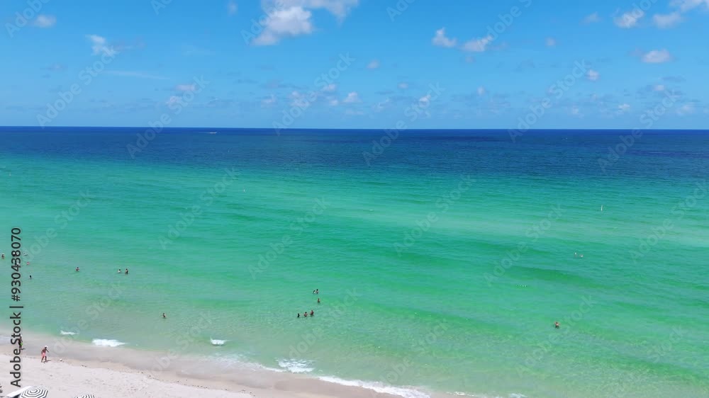 Aerial view on turquoise ocean at sunny isles beach with tourists relaxing on sun loungers under umbrellas. Exotic destination for luxury holidays and tropical vacation Aerial view on turquoise ocean at sunny isles beach with tourists relaxing on sun loungers under umbrellas. Exotic destination for luxury holidays and tropical vacation