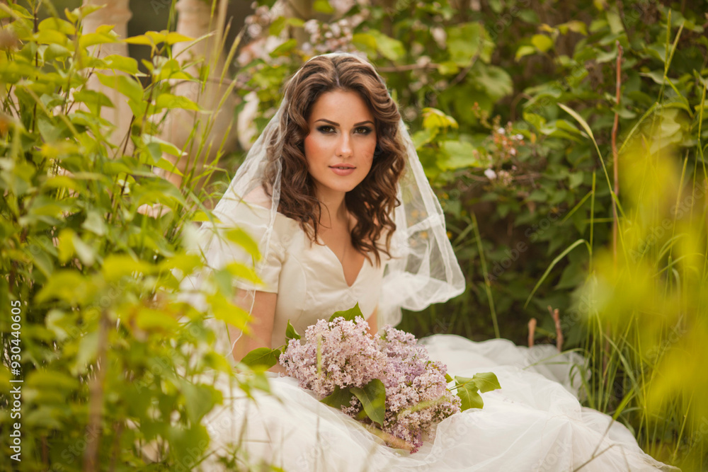Portrait of beauty bride in white dress. The bride is holding a wedding bouquet of lilacs. Portrait of beauty bride in white dress. The bride is holding a wedding bouquet of lilacs.