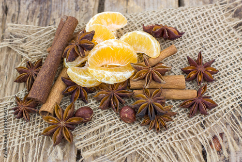 cinnamon sticks, star anise spices, tangerine and nuts - christmas time