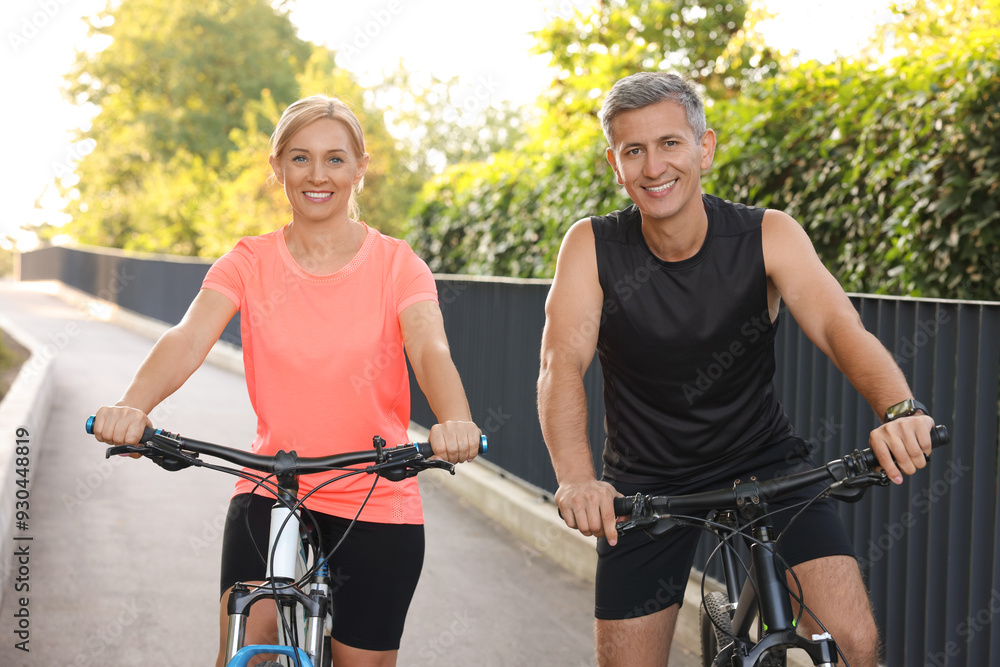Obraz premium Happy couple with bicycles in park. Healthy lifestyle