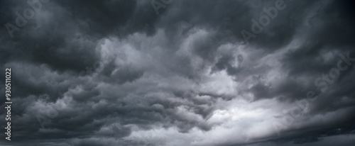 The dark sky with heavy clouds converging and a violent storm before the rain.Bad or moody weather sky and environment. carbon dioxide emissions, greenhouse effect, global warming, climate change.