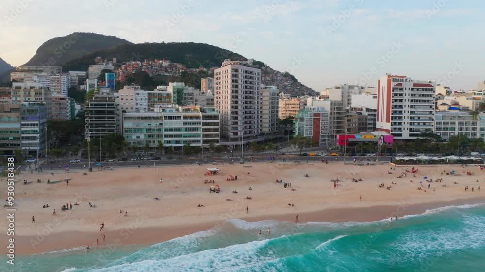 Aerial view of Ipanema Beach in Rio de Janeiro, Brazil, with waves hitting the shore and buildings along the coast. Aerial view of Ipanema Beach in Rio de Janeiro, Brazil, with waves hitting the shore and buildings along the coast.