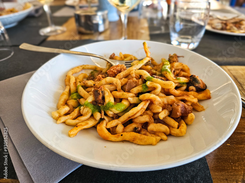 Strozzapreti alla marinara freshly prepared pasta with seafood served at a cozy restaurant during lunchtime in  San Marino