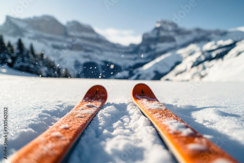 Skiing in the snowy mountains with vibrant skis on a clear, sunny day