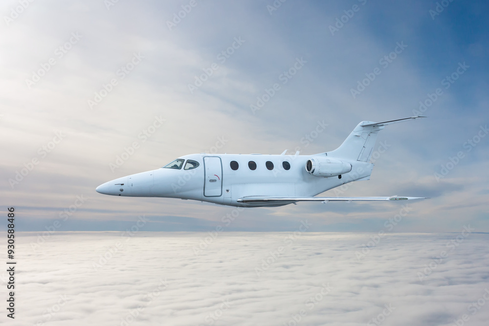 White executive airplane flying in the air above the clouds White executive airplane flying in the air above the clouds